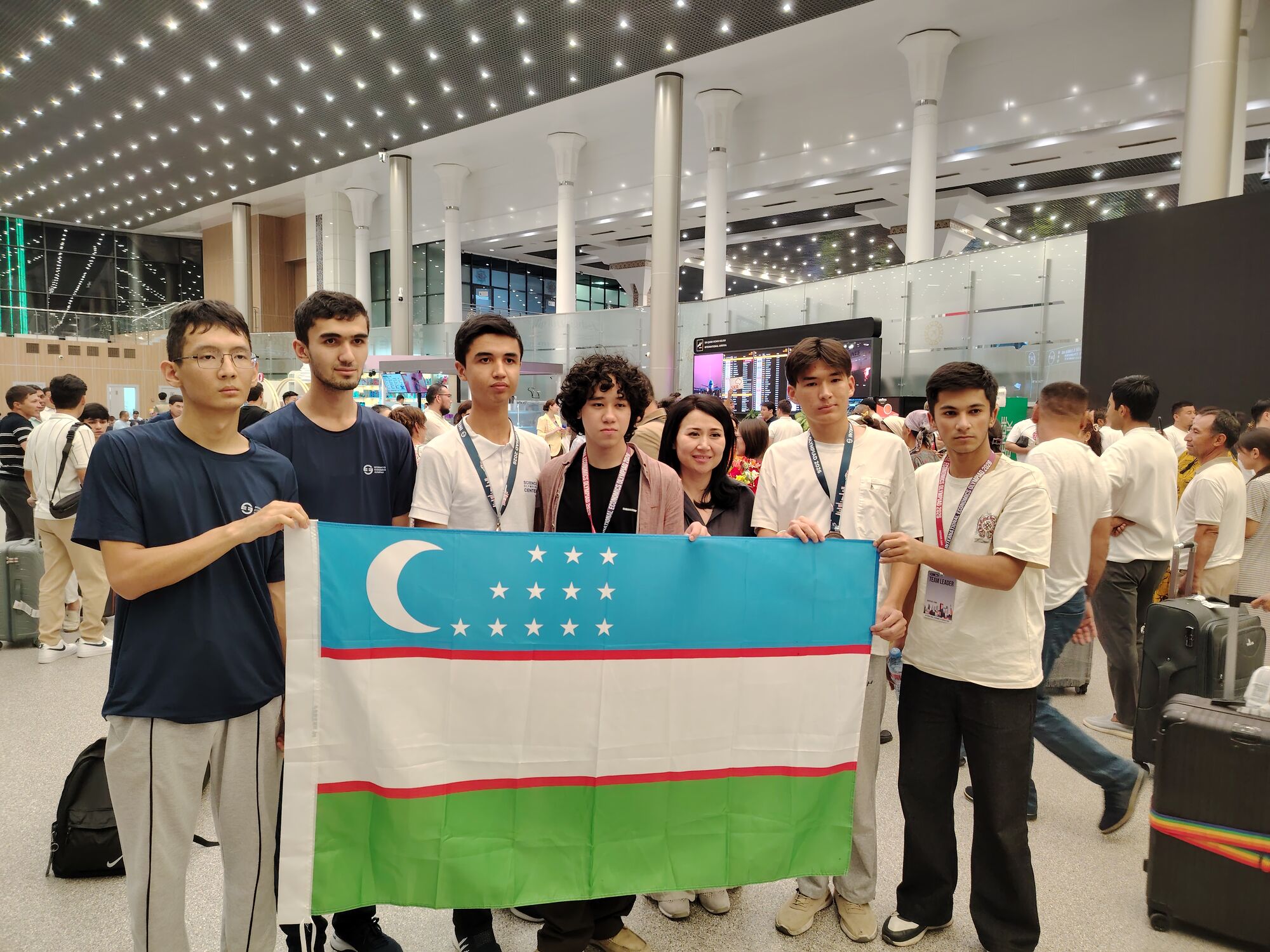 Team Uzbekistan holding the national flag at IEO 2026