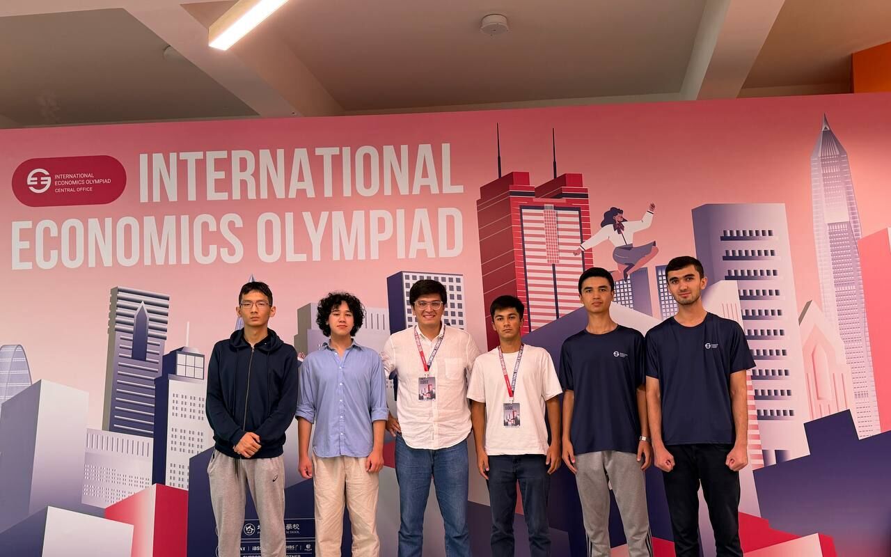 The team with Bekzod Hoshimov at the International Economics Olympiad