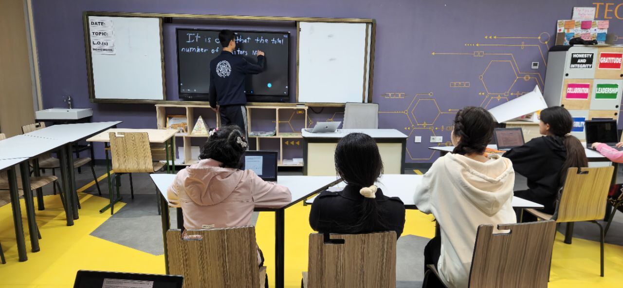 Asliddin teaching SAT at the whiteboard